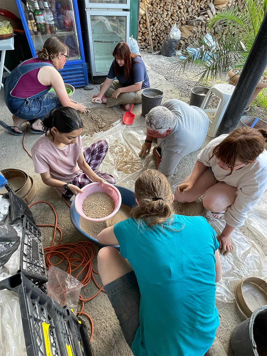 Group of students processing clay to make pottery
