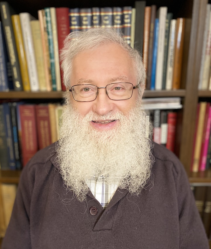 Prof. Harry Fox standing in front of a bookshelf