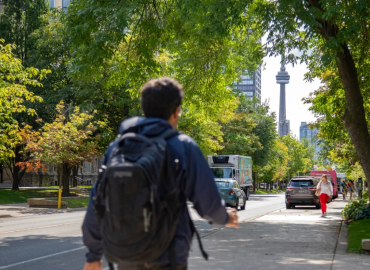 Student walks down St. George st. at the University of Toronto St. George campus